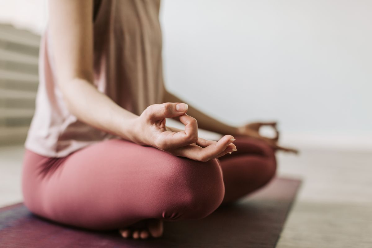 Woman meditating quietly indoors